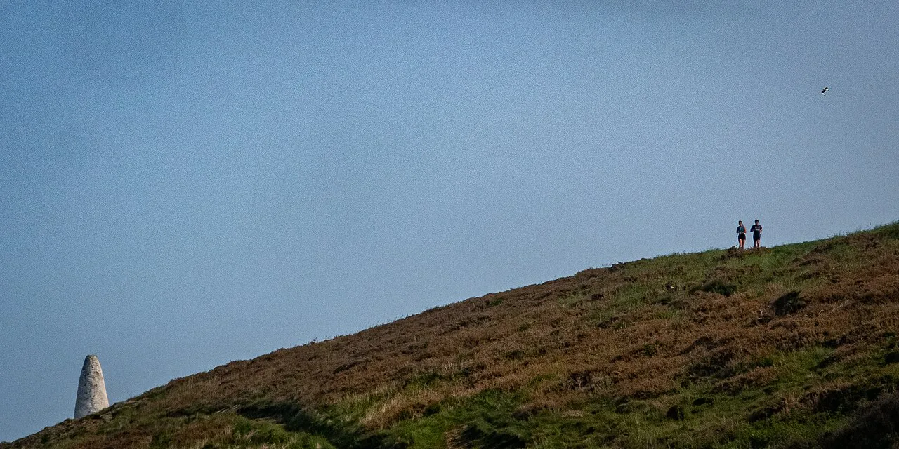 Porthgain Harbor Pillar with Hikers, Wales